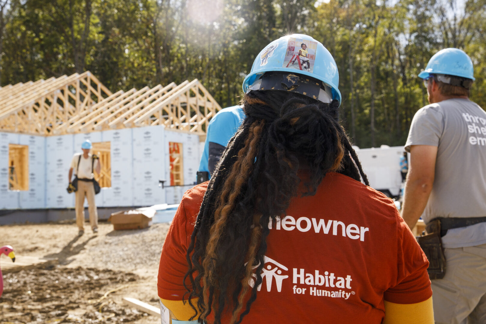 A Habitat for Humanity homeowner looks at her home being built.